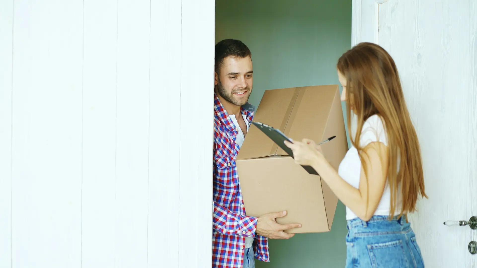 Couple signing for a package at the door