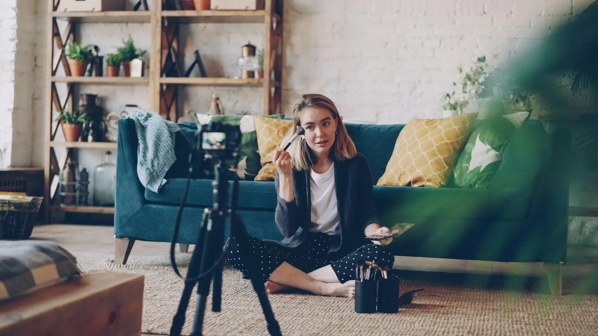 Woman applying makeup for camera