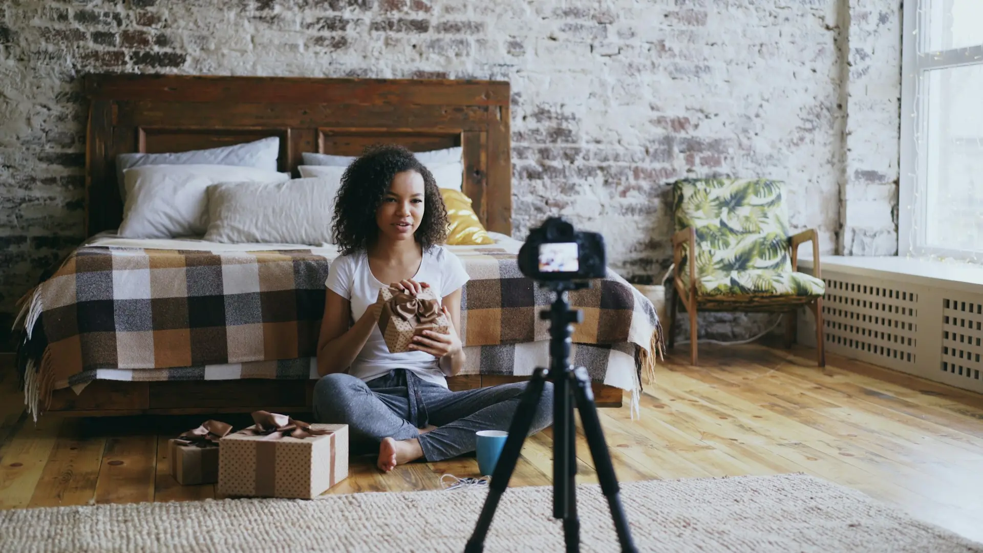 Woman filming herself with a camera on a tripod