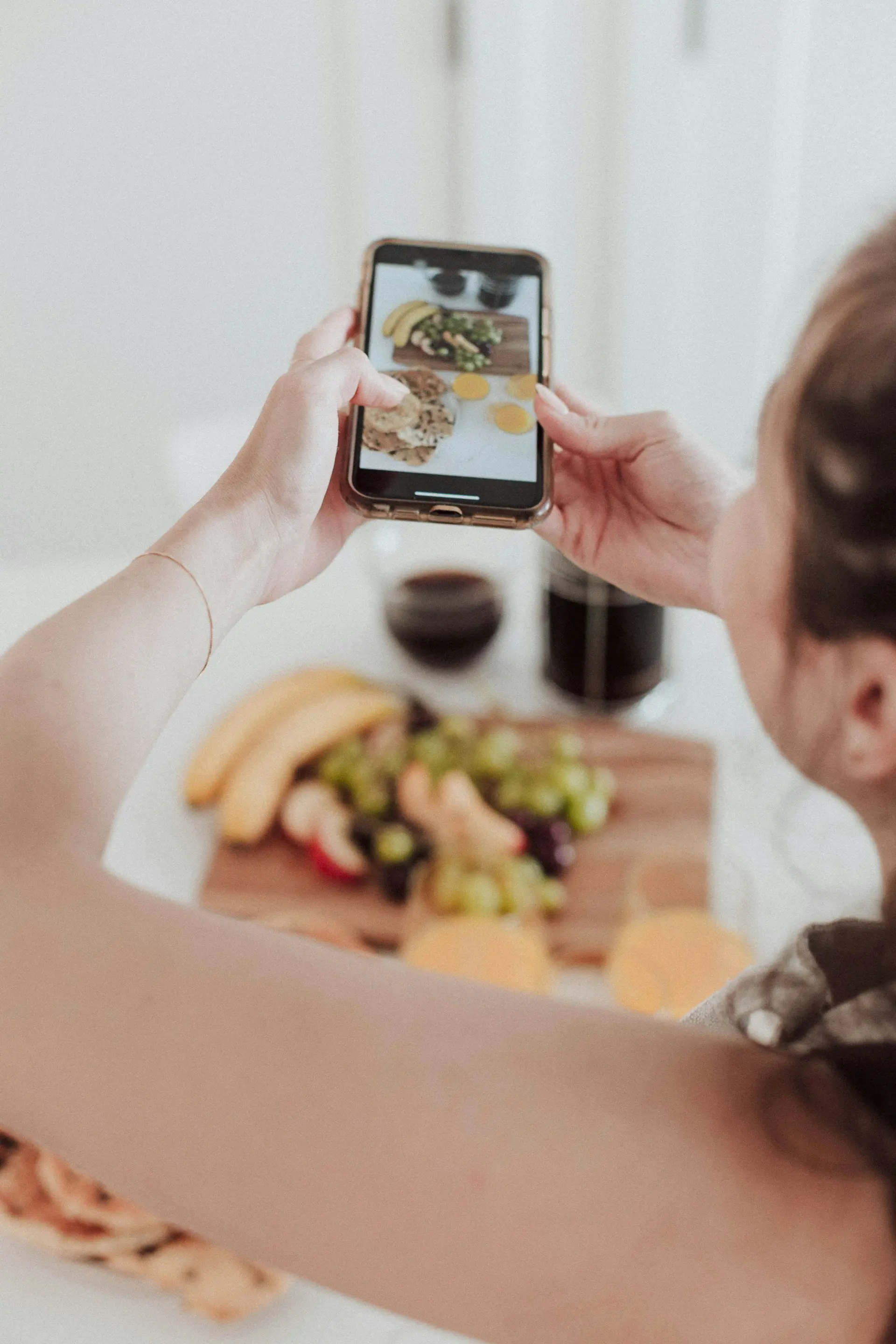 Woman taking a picture of food on her phone