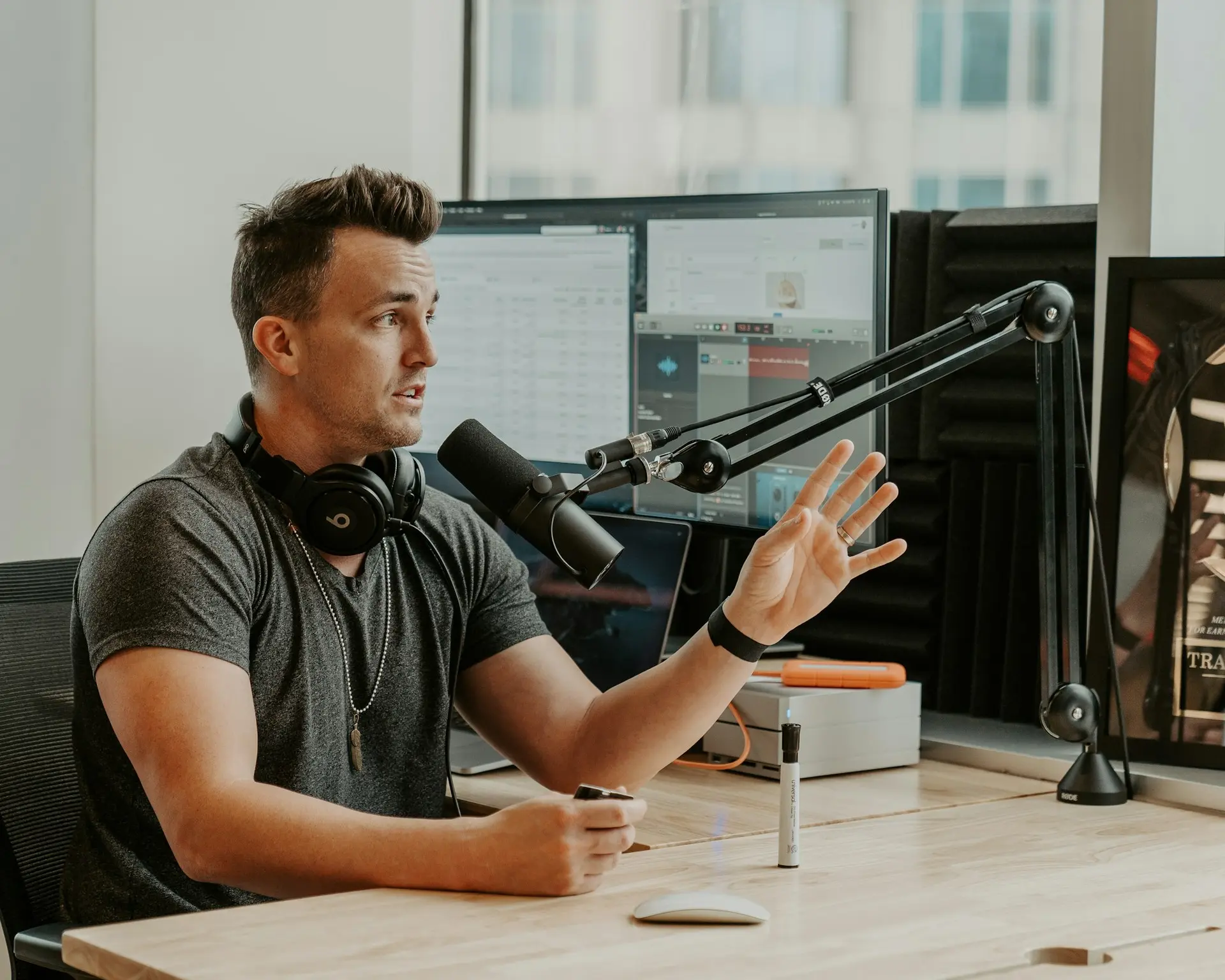 Man speaking into a microphone at a table