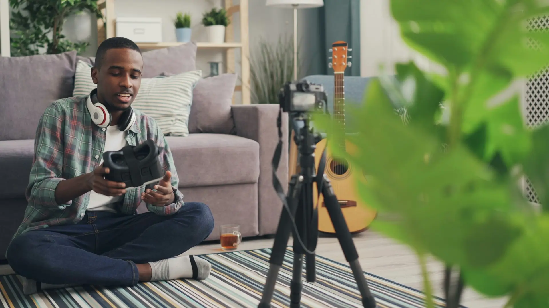 Man recording a video on the floor at home