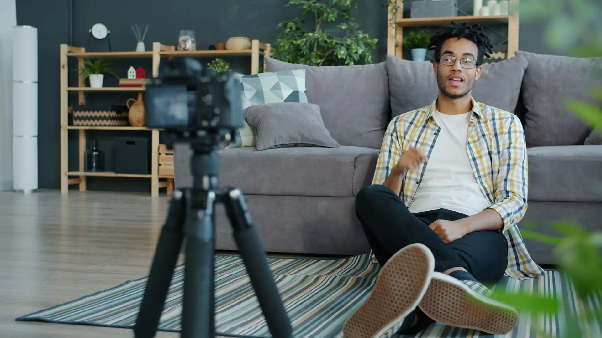 Man recording himself with a camera at home