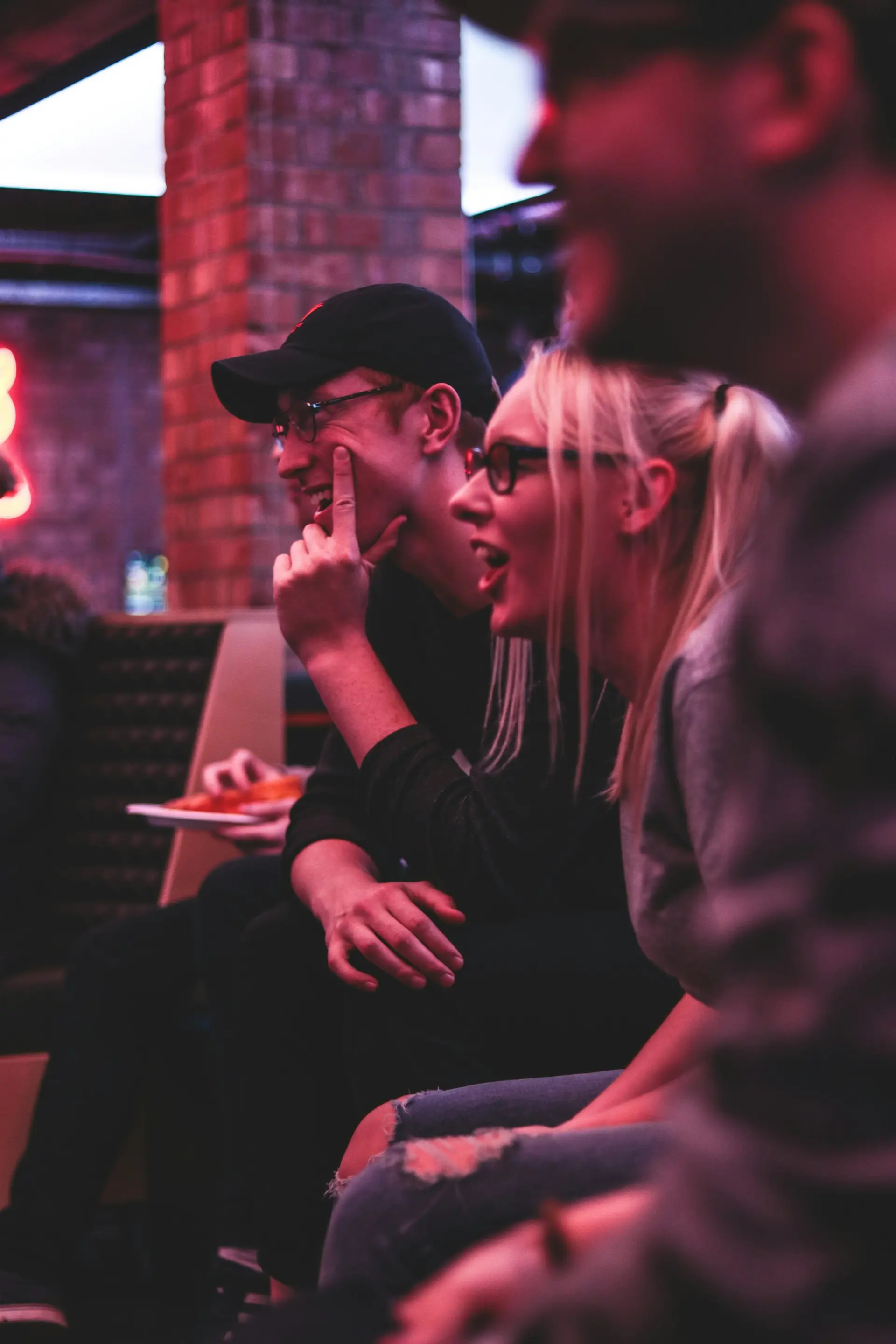 Woman sitting between two friends, smiling