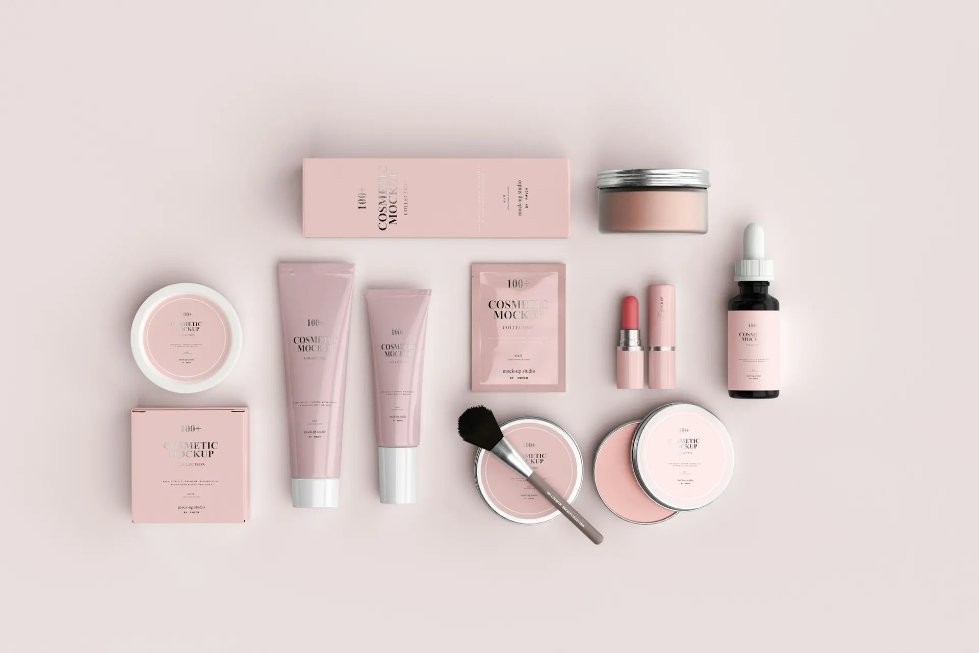 Pink cosmetic containers and a brush